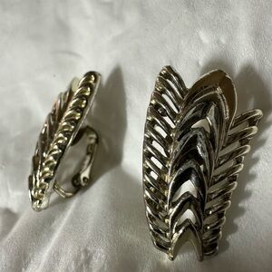 A vintage signed Lisner/Coro silver toned feather/leaf design clip on earrings